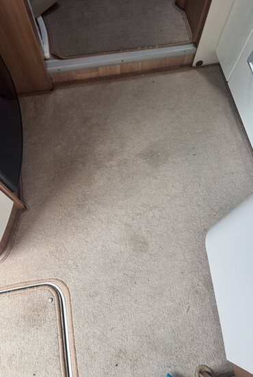 Dark stair carpet cleaned with a stair tool