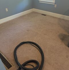 Hose run into a home for a carpet cleaning appointment