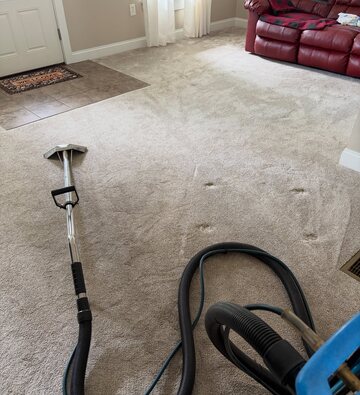Truck-mounted extraction wand cleaning carpet in a Goose Creek home